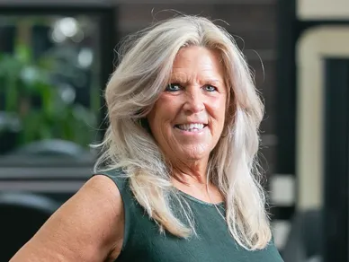 woman with blonde hair and green shirt